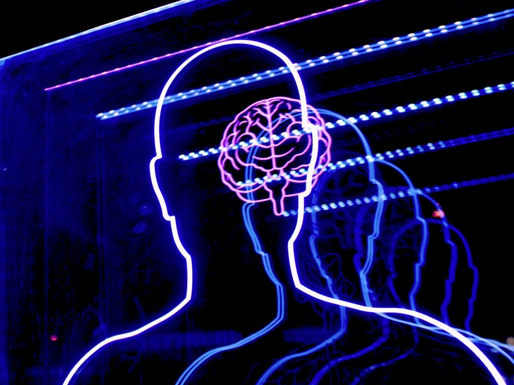 Outline of a person and a digital brain as Anthropic provides a more detailed look into the complex inner workings of their advanced language model Claude to demystify how these sophisticated AI systems process information, learn strategies, and ultimately generate human-like text.