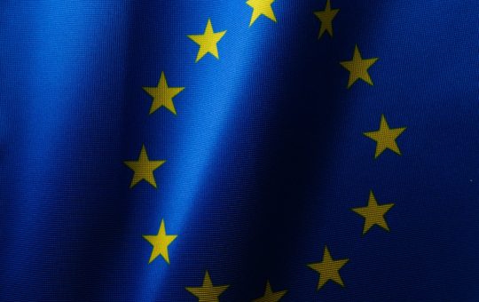 Flag of the EU as the European Commission has seen a flood of interest from companies looking to help create AI Gigafactories across Europe develop and train the next generation of artificial intelligence systems.