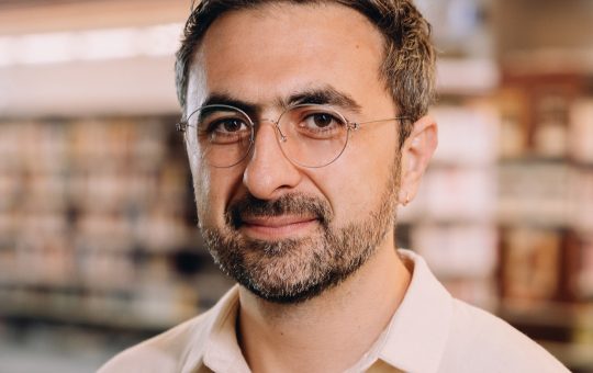 Photo of Microsoft AI CEO Mustafa Suleyman as he warns that Anthropic risks AI alignment failures by training Claude to view itself as a conscious entity deserving of legal rights.